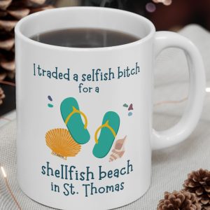 White Mug with the image of sea shells and sandals and the saying, "I traded a selfish bitch for a shellfish beach in St. Thomas."