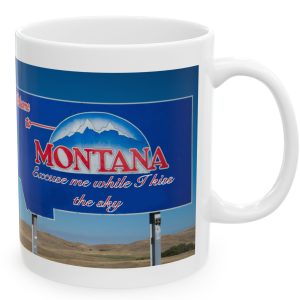 White Mug with fake state motto for Montana: "Excuse me while I kiss the sky."