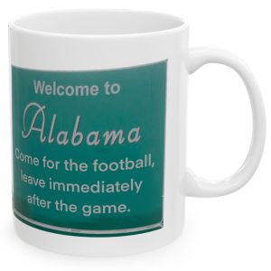 White Mug with fake state motto for Alabama: "Come for the football, leave immediately after the game."