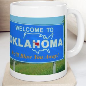 White Mug with fake state motto for Oklahoma: "We'll Blow You Away!"
