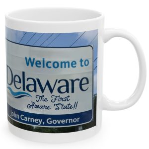 White Mug with fake state motto for Delaware: "The First Aware State!!"