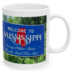 White Mug with fake state motto for Mississippi: "Every Other State Thanks God for Us!."