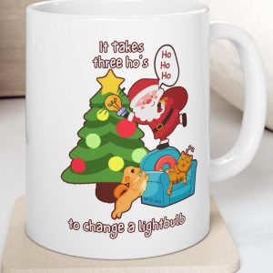 White Mug with Santa and the saying "it takes three ho's to change a lightbulb."