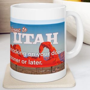 White Mug with fake state motto for Utah: "Knocking on your door sooner or later."