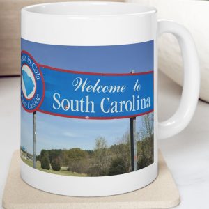 White Mug with fake state motto for South Carolina: "Peanuts in Cola is Haute Cuisine."