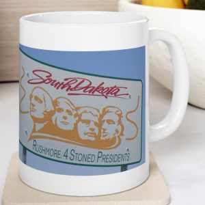White Mug with fake state motto for South Dakota with the saying: "Rushmore: 4 Stoned Presidents."